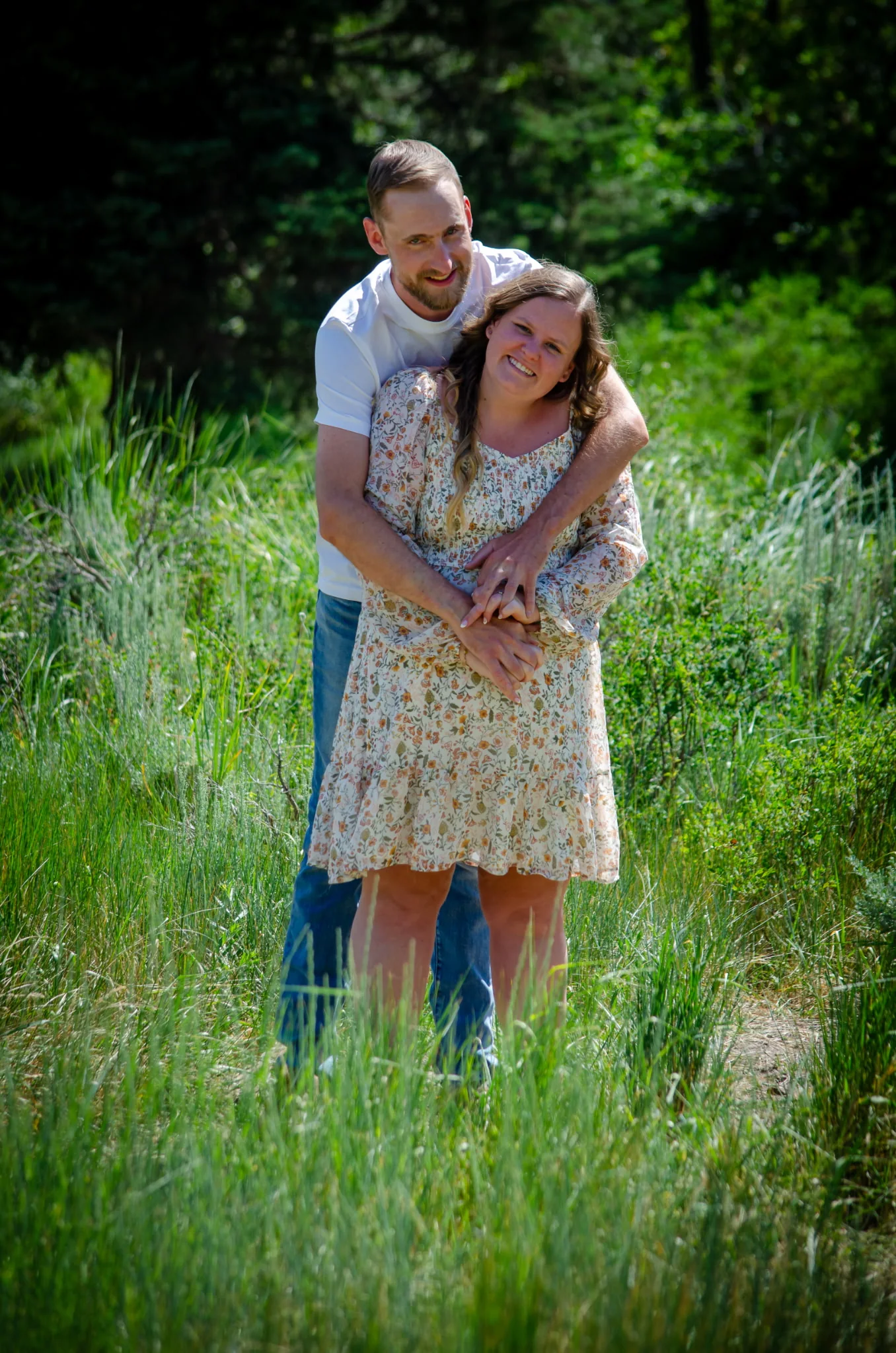 Tiff and Mitch embracing in tall grass